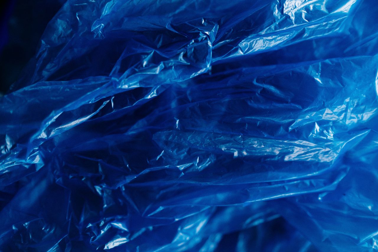 A vibrant close-up of crumpled blue plastic showcasing texture and recyclability.